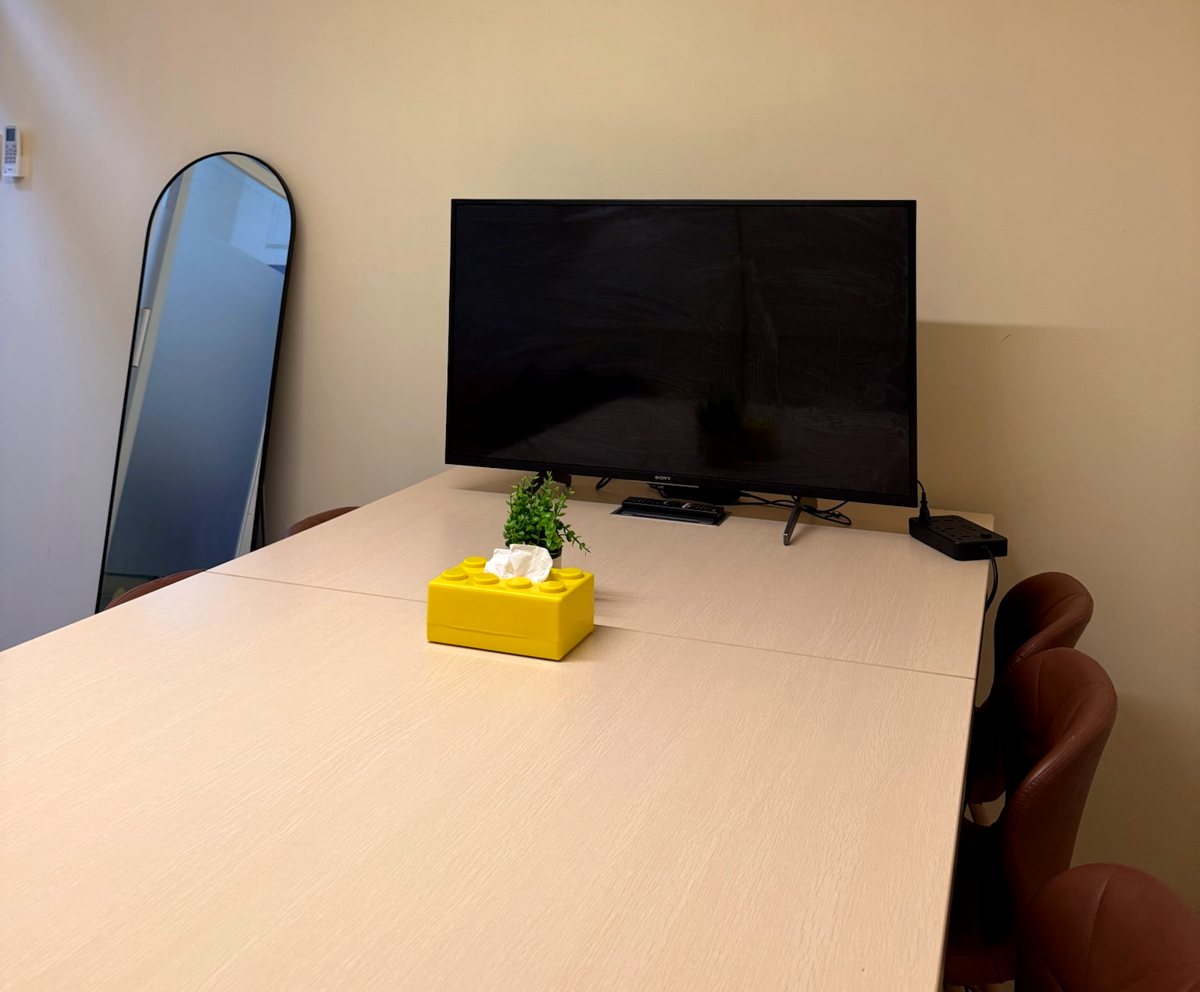 Snap & Sip conference room with TV and meeting table